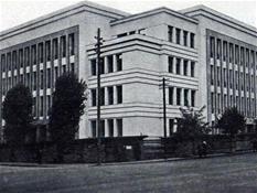 <p style="text-align: justify;">Kaunas County Board, Office of the Governor of Kaunas City and County, Chief of Police of Kaunas City and County and the Department of State Security established their offices in one of the largest administrative buildings of the interwar Lithuania. The basement accommodated institutional archives, apartments of couriers, boiler-house and other rooms. A two-storey garage with apartments for drivers and a printing-house were built in the yard. "During the Soviet period, the building served as the seat of the KGB."</p>
<p style="text-align: justify;">As it pertains to a significant object of public importance, architectural solutions had to create the impression of solidity and representation. The base and stairs of natural sombre granite, the black polished labradorite portals and the pilasters of dark artificial granite contrasting with light granite façades, and a solid two-tier cornice shaped an object which stood out from the surrounding context for both modern clear geometrical forms and luxury. Based on archival data, we may presume that the object was to render an even greater representative effect from the side of Laisvės avenue by building "large stairs in place of a pavement". In fact, the Construction Commission of Kaunas City Municipality did not agree with such construction of stairs by noting that "such a pavement occupation is not compatible with the layout of Laisvės avenue".</p>
<p style="text-align: justify;">The structure of the building also manifested modernity and innovation (designers J. Šalkauskas and A. Rozenbliumas) - even though the building was built of bricks, "a supporting reinforced concrete framework was designed in the centre of the chief walls of two wings. Iron columns were built in important spots of the exterior walls". In fact, the use of the reinforced concrete structure considerably increased the price of the building, whereas the layout structure of the object was rather commonplace - rooms and other premises were arranged in line with the corridor system.   </p>
<p style="text-align: justify;"><em>Vaidas Petrulis</em></p>